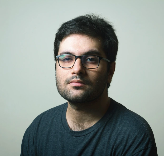 man in black crew neck shirt wearing black framed eyeglasses