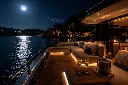 Moonlit yacht on calm waters.webp